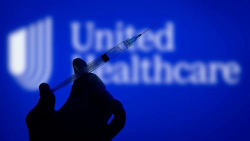 Dhaka, Bangladesh- 06 Dec 2024: A gloved hand holding a syringe in front of the UnitedHealthcare