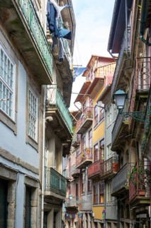 Historic buildings narrow street houses with balconies, Ribeira district, city of Porto, Portugal