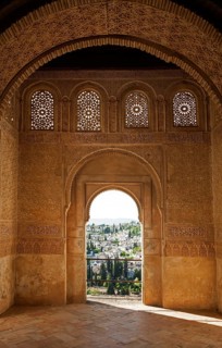Stone arches in Islamic key shape in the Generalife palace, Alhambra, Granada, Spain