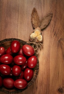 Painted eggs in a wooden bowl, red, painted madder dye, powder from the roots of endro, with onion