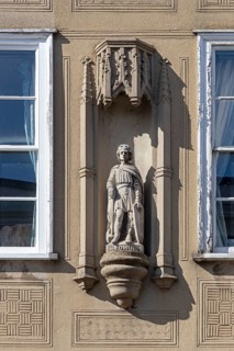 St Edmund statue on the wall of a house, Bury St Edmunds, West Suffolk, England, Great Britain