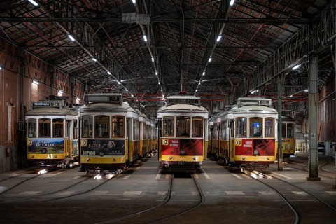 LISBON, PORTUGAL - MAY 19, 2025: Historic trams stand in the tram depot at night