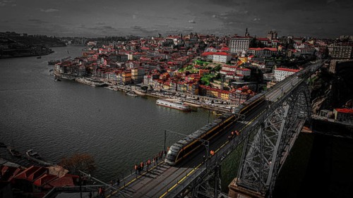 Dark cityscape with illuminated city, Ponte Dom Luis 1 bridge over the Douro and strong contrasting