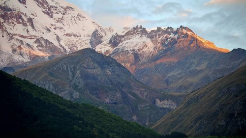 Snow-capped mountains at sunset, peaceful natural landscape, Stepantsminda, Caucasus, Georgia