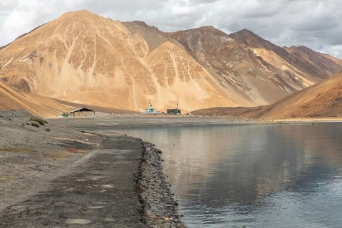 Scenic view of Pangong Tso lake in Ladakh, India, surrounded by the majestic Himalayas with calm
