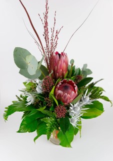 Elegantly tied bouquet with protea and eucalyptus branches, looks fresh and lively, bouquet