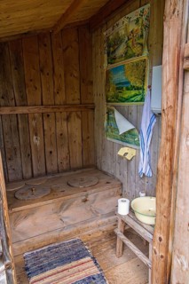 Interior of an old idyllic wooden outhouse with space for two in the countryside, Sweden