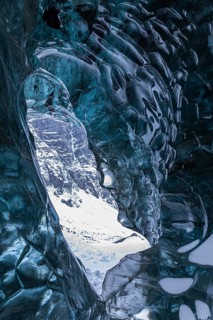 Ice cave open to the top with snow-covered ice combs, Pröng ice cave, Sudurland, Iceland