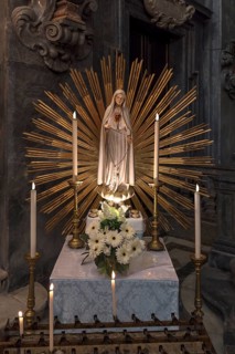 Marian altar with sacrificial candles in the Chiesa dei Santi Vittore e Carlo, built in 1650, Via
