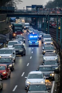 Traffic jam on the A40 motorway, emergency lane, vehicles on the left and right, police patrol car