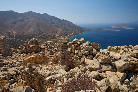 Ruins overlooking the sea surrounded by hills and natural coastal scenery, Johanniter fortress from