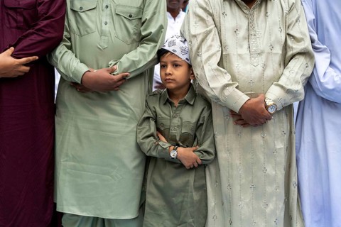 A Muslim child with elders attend to Eid al-Fitr prayer at Eidgah, on March 21, 2026 in Guwahati,