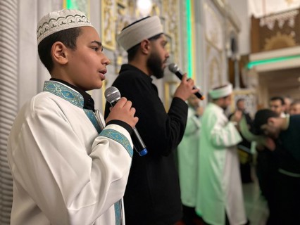 Dozens of Muslims stand in a long queue to view a sacred piece of the Kaaba curtain (Kiswa) while