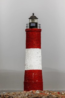 Close-up of a lighthouse on rocks in stormy weather, The lighthouse in the Beagle Channel near