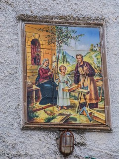 Mural depicting the Holy Family with Jesus as a child, Joseph as a carpenter and Mary spinning