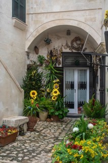 Entrance door with flowers in Matera, Basilicata, Southern Italy, Italy