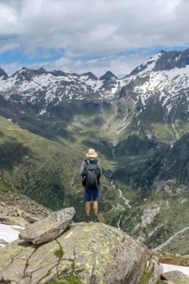 Mountaineers in front of a picturesque mountain landscape, rocky mountain peaks with snow, view of