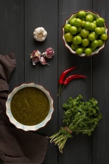 Tkemali sauce, traditional Georgian cuisine, green cherry plum, with ingredients for sauce,