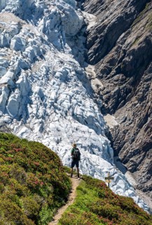 Mountaineer on a hiking trail in front of a glacier, glacier tongue Glacier de Taconnaz, Chamonix,