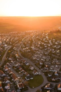 Aerial view of a settlement at sunset with rolling hills, Calw, Stammheim, Calw district, Germany