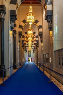 Side corridor with illuminated chandeliers in the Sultan Qaboos Mosque, Muscat, Arabian Peninsula,