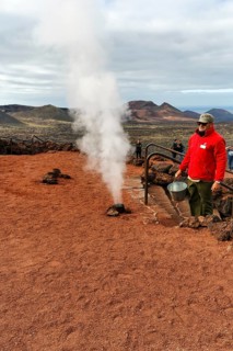 Demonstration for tourists, volcanic activity, steam geyser, fire mountains of Timanfaya National