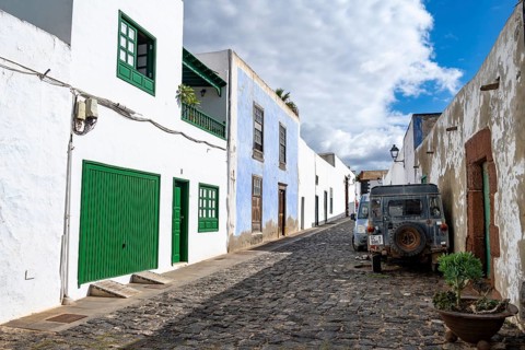 Typical white houses with colored doors and windows in an alley, Teguise, Lanzarote, Canary