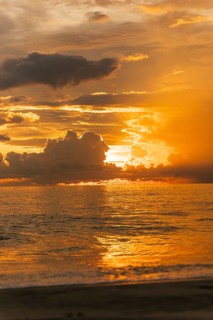 Majestic golden sunset over the ocean in Bali, Indonesia, reflecting vibrant hues of orange and