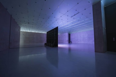 Modern room with shades of blue and purple, empty and industrial, with light installation,