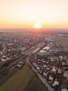 Peaceful aerial view of a small town at sunset with houses and fields, Althengstett, district of