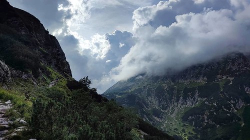 Dramatic cloud formations over high mountains and a steep trail, Zakopane, hiking in the High