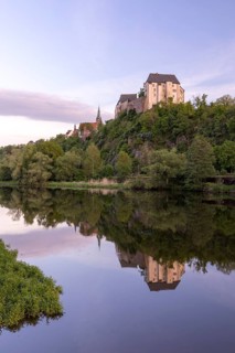 Mildenstein Castle and St Matthäi Church reflected in the Freiberger Mulde, Leisnig, Saxony,