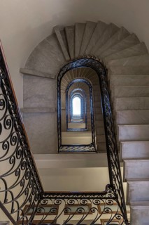 Staircase around 1900 with a wrought-iron banister, in a residential building, Genoa, Italy