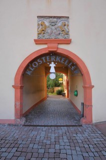 Inner courtyard and entrance to the Klosterkeller restaurant with coat of arms, passageway,