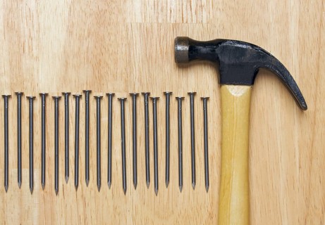 Hammer and Nails Abstract on Wood Background
