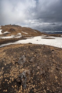 Snow-covered volcanic landscape with tuff and petrified lava, crater of Askja volcano, Icelandic