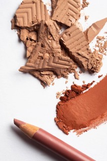 A vivid display of crushed eye shadow and makeup powder showcasing texture and color contrasts.
