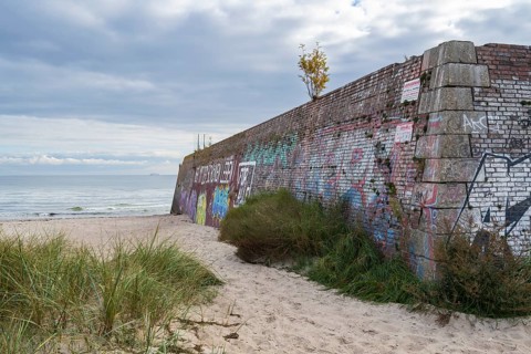 Old harbor wall on the beach near Prora, dark clouds in the sky, Binz, Rügen, island, Baltic Sea,