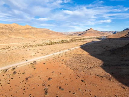 Aerial view, Eternally long straight road, road C14 through the Naukluft Mountains, desert and dry