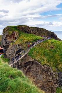Narrow suspension bridge for walkers on rocky coast, Rope Bridge Carrick-a-Rede, footpath,