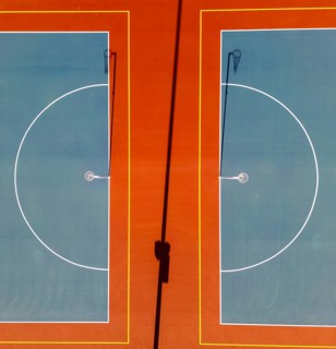 Top view captured by a drone of two netball courts. The aerial perspective highlights the geometric