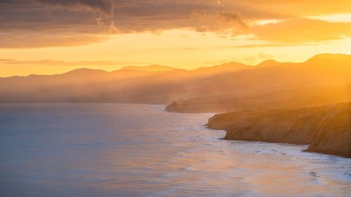 Wairarapa coast at sunset. Sea, mountains, backlight. Castlepoint, Wairarapa Coast, Wellington