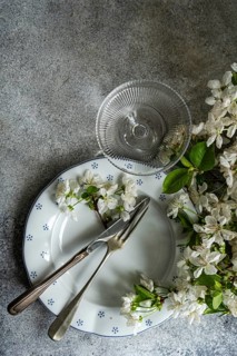 An elegant table setting featuring a vintage plate with a fork and knife, accompanied by delicate