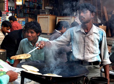 New Delhi, India, 15.01.10 - market scene, food stand, sale of pancakes, India