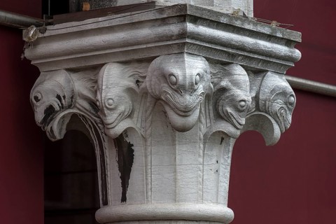 Captain design with fish figures on the arcades of the historic market in Rialto, Venice, Veneto,