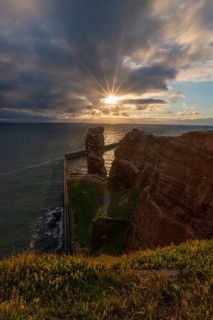 Red red sandstone cliff edge, Heligoland high sea island, Lange Anna, backlight, North Sea, blue