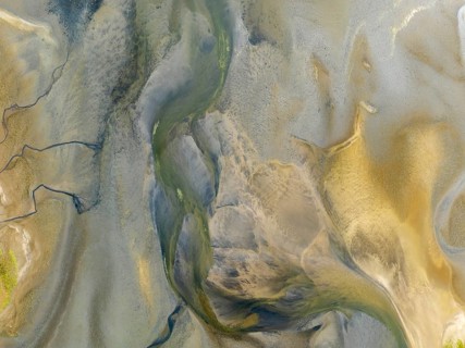 Streams and marshes at low tide in the wetlands of the Walvis Bay lagoon. In the distance Greater