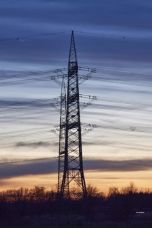Electricity pylons and power lines in the sunset in Bohmte, Osnabrück district, Lower Saxony,