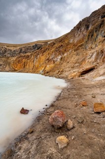 Colourful rock at the crater lake Víti in the crater of the volcano Askja, volcanic landscape,