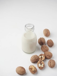 Homemade vegetable nut drink. Vegan milk, lactose free in glass bottle and hazelnuts